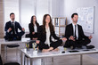 © Andrey Popov - Businesspeople Meditating In Office