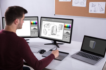 Poster - Designer Drawing Suitcase On Computer Using Graphic Tablet