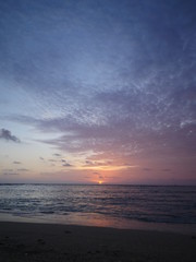 sun setting into the ocean horizon Hawaii