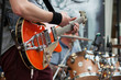 © pixarno - closeup of guitarist playing guitar with rock group in the street