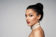 © paffy - Beauty closeup portrait of beautiful mixed race woman wearing chocker looking at camera, isolated on gray background