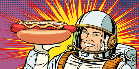 smiling male astronaut presents hot dog sausage