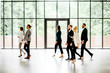 © rh2010 - Business people walking at the modern hall on the window background indoors. long exposure image technic with motion blurred people