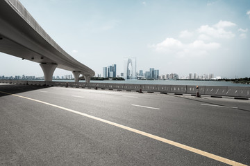 asphalt road with city skyline