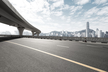 asphalt road with city skyline