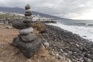 Puerto de la Cruz. Stone piles ( Cairns) on Playa Jardin, Peurto de la Cruz, Tenerife, Canary Islands, Spain. Selfmade rock-monument at the beach of Puerto de la Cruz Tenerife.