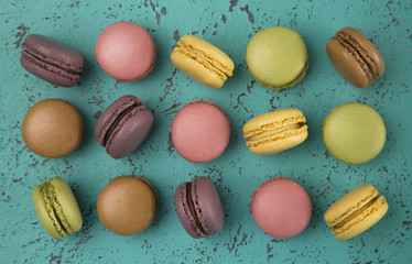 Wall Mural - A Variety of French Macarons Flavors on a Textured Turquoise Background