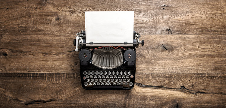 Antique typewriter grungy textured paper wooden background