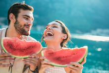 Cheerful Couple Holding Slices Of Watermelon