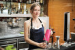 © olly - Smiling woman preparing a cocktail