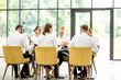 © rh2010 - Business people dressed in white shirts sitting together during a business lunch in the modern restaurant with big window on the background