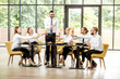 © rh2010 - Man speaking toast during a business lunch with colleagues sitting at the spacious restaurant with big window on the background