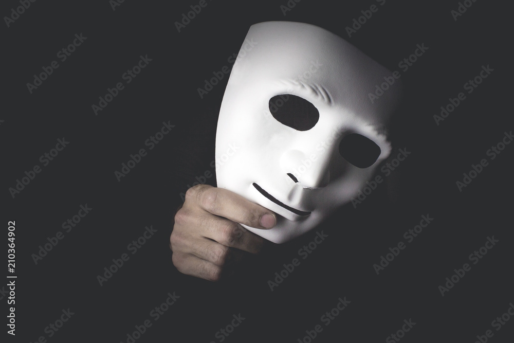 white mask in hand