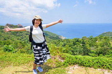 Wall Mural - Women tourists extend the arms happily at high viewpoint to see the beautiful nature landscape of the sea and island on top of the Koh Tao island is a famous attractions in Surat Thani, Thailand