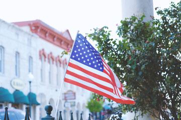Wall Mural - USA flag with old American buildings in background, celebration of july 4.
