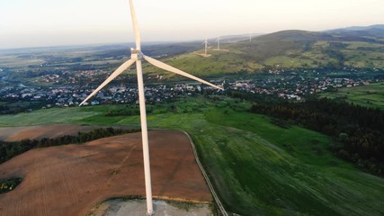 Wall Mural - aerial view of ecological windmill farm on summer sunset over the mountains scenic landscape wind turbines in motion ecologically friendly clear rural area freshness future technology eco lifestyle
