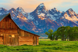 Fototapeta Pomosty - This abandoned, vintage barn in Mormon Row has the Grand Tetons in the background.  Located in Jackson Hole, Wyoming, it is listed on the National Register of Historic Places.