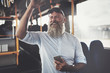© Flamingo Images - Smiling mature man riding a bus listening to music