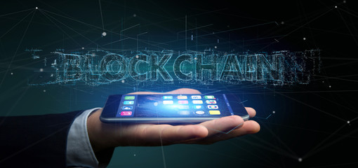 Poster - Businessman holding a Blockchain title isolated on a background