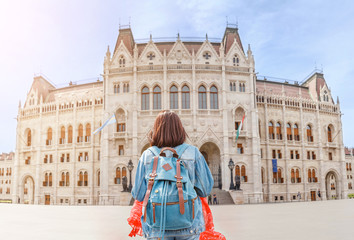 Wall Mural - Happy asian casual woman student enjoying great view of the Parliament building in Budapest city, travel in Europe concept