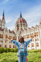 Wall Mural - Happy asian casual woman student enjoying great view of the Parliament building in Budapest city, travel in Europe concept