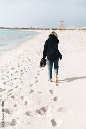 alone girl walking on beach