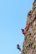 © Amateur007 - Rock climbing. A group of young rock climbers climb the vertical granite rock. Extreme sport.