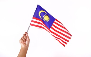 Hand holding Malaysia flag isolated on white background