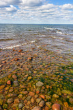 Fototapeta Morze - Waves rolling in from two directions towards the reef in the lake