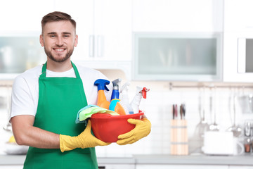 Wall Mural - Man in uniform with cleaning supplies indoors