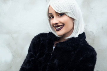 Young smiling woman in fur jacket