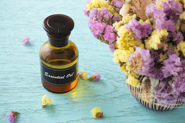 Bottle of essential oil with flower