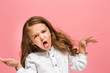 © master1305 - Portrait of angry teen girl on a pink studio background