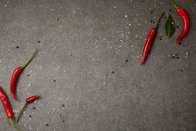 Top View Of Chili Peppers And Scattered Spices On Grey Table