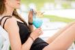 © rh2010 - Woman in black swimsuit with beautiful summer cocktail relaxing outdoors, close-up view