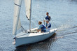 © pressmaster - Three men in lifejackets sitting in yacht and sailing in the sea during weekend trip