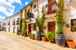 Wine shops and restaurants on narrow street in white Andalusian village with typical Spanish architecture, Zahara de la Sierra, Spain