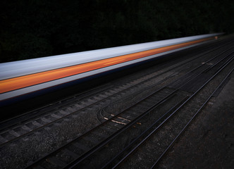 Wall Mural - Speeding fast train on an isolated black background