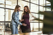 © Viacheslav Yakobchuk - Future mother. Attractive college touching pregnant woman belly and gazing down