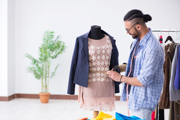 Male tailor working in the workshop on new designs