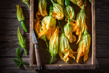 Fresh And Healthy Zucchini Flower In Old Wooden Box