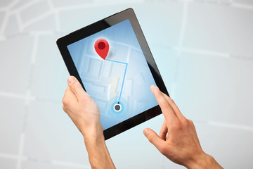 Female fingers touching tablet with map