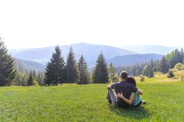 Wall Mural - Hugging Man and Woman Enjoying Landscape