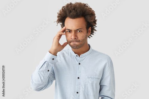 Serious Mixed Race Curly African American Male Employee Keeps