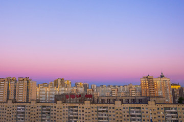 Wall Mural - Aerial view of dramatic sunset or sunrise abstract urban skyline cityscape on twilight time.