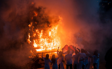 retail of silhouette of people  in front of bonfire