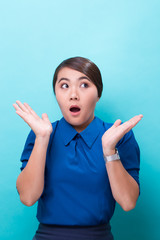 Wall Mural - Surprised woman on isolated blue background