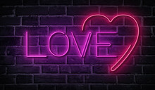 Love Neon Word On Brick Wall. Pink Glowing Signboard.
