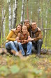 © aletia2011 - Happy smiling family in autumn forest sitting