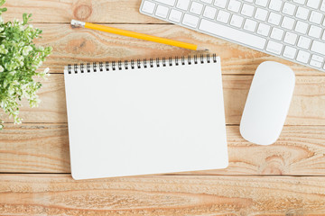 Wall Mural - blank notebook and yellow pencil on brown wood,flat lay photo of notebook for your message